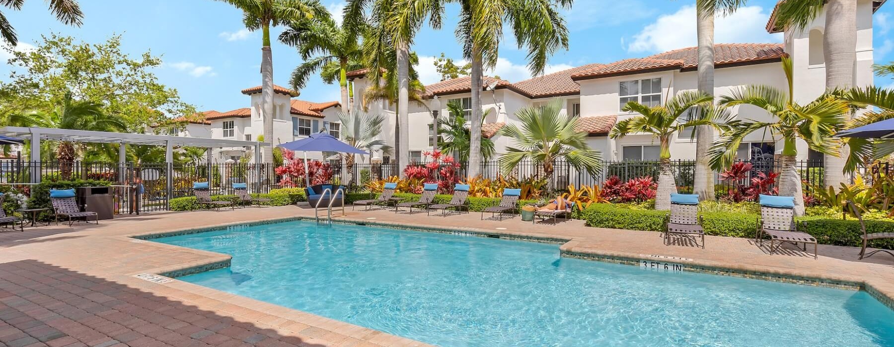 The Isles community pool surrounded by palm trees