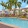 Sparkling community swimming pool with surrounding palm trees at The Isles